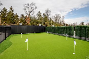 A golf course with green grass and white flags.